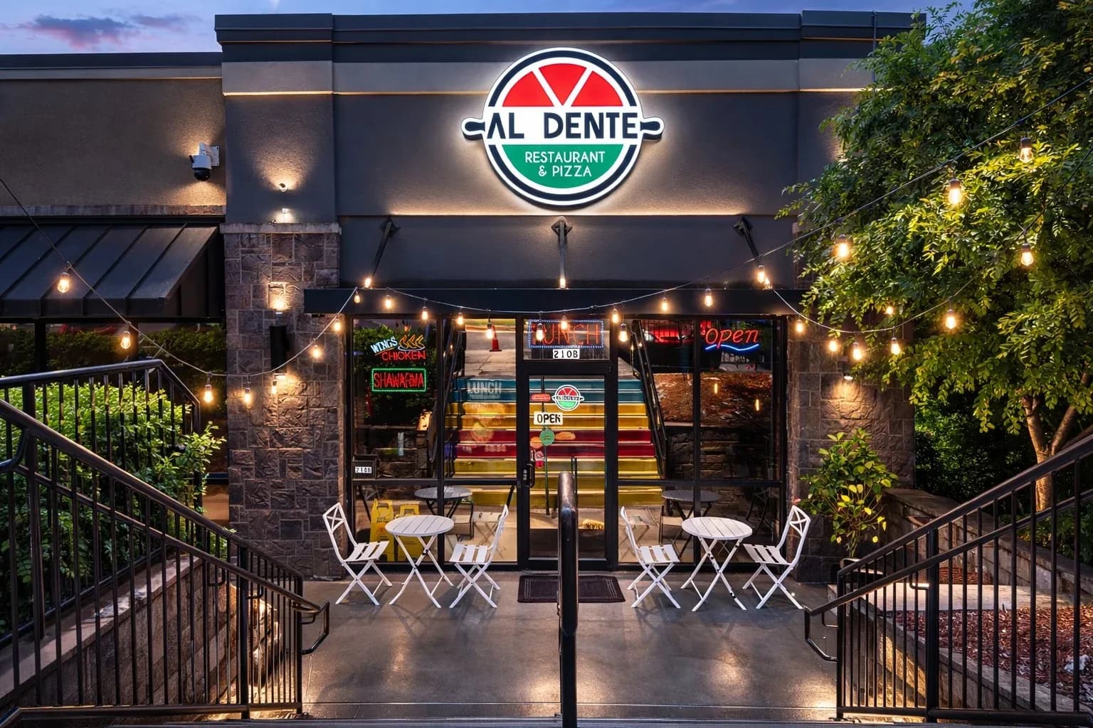 The Al Dente storefront in Duluth at dusk, with the lit sign above the door