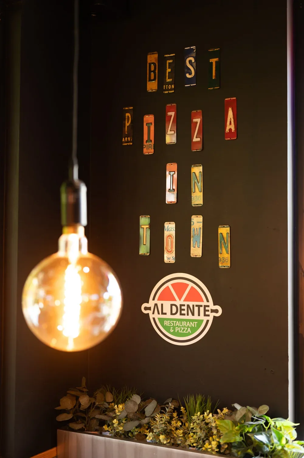 "Best pizza in town" spelled out in vintage licence-plate letters above the Al Dente logo